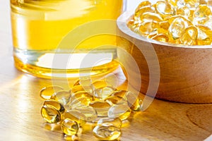 Cod liver oil or Fish oil capsules in wood bowl on wood