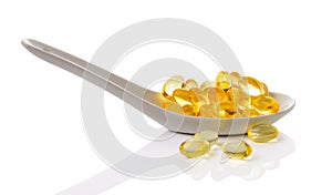 Cod liver oil omega 3 gel capsules in spoon