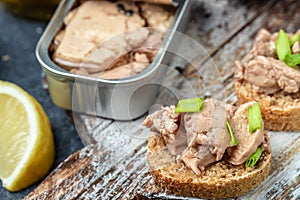 Cod liver over brown bread with green onion, Food recipe background. Close up