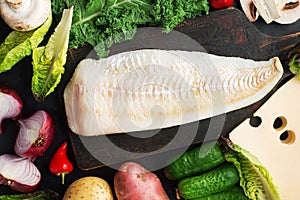 Cod simple healthy food ingredients: white fish, vegetables, mushrooms, green leafy salads, onions, cabbage, kale, hot
