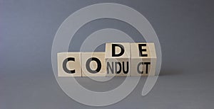 Code of conduct symbol. Turned cubes with words Conduct abd Code. Beautiful grey background. Business and Code of conduct concept