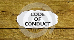 Code of conduct symbol. Words `Code of conduct` on white paper. Beautiful wooden background. Business and code of conduct concep