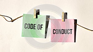 Code of conduct text words inscription on yellow sticker note on white wall or table