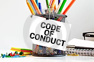 Code of Conduct Text written on notebook page, red pencil on the right