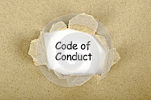 Code of conduct word written on torn paper