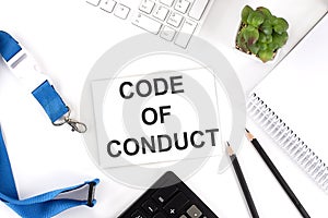 CODE OF CONDUCT Words on the card with keyboard and office tools photo