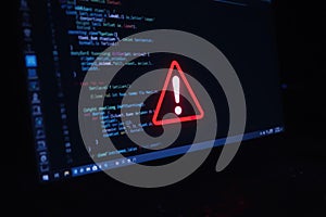 Code error alert showing on a computer screen at night