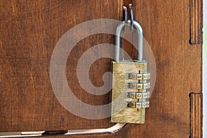 Code padlock on wooden small door