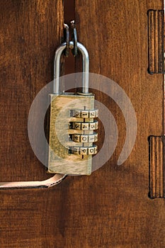 Code padlock on wooden small door