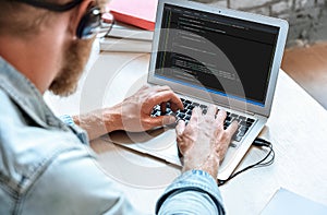 IT coder programmer use laptop computer typing coding on notebook screen