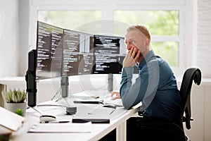 Coder Using Computer At Desk photo