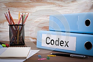 Codex, Office Binder on Wooden Desk. On the table colored pencil