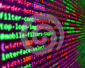 Coding application by programmer developer. Screen of web developing code on dark background. Software developer programming code