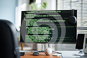 Coding on Computer Monitor in Modern Office Workspace