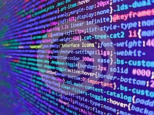 Coding css on mornitor at the office - for background or montage product. Mobile app building. Abstract source code background.