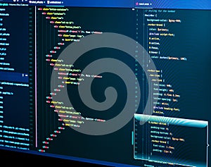 IT coding on monitor screen. HTML markup language closeup. Programming code. Close up of Script, CSS and HTML code