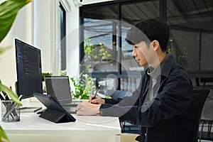 Coding programmer working on software development on desktop computer at modern office