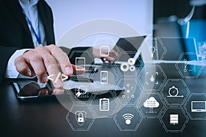 businessman working with smart phone and digital tablet and laptop computer in modern office with glass reflected view