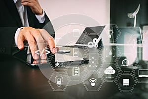 businessman working with smart phone and digital tablet and laptop computer in modern office with glass reflected view