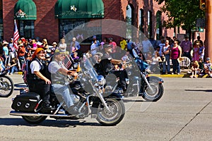 Cody, Wyoming, USA - July 4th, 2009 - Man and woman riding a motorcycle together in the Independence Day Parade