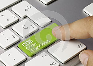 COE Center of Excellence - Inscription on Green Keyboard Key