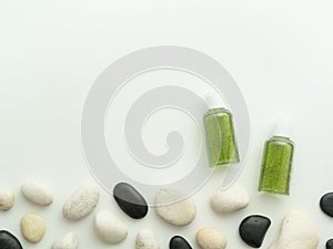 Coemetic bottles and spa stones isolated on white background