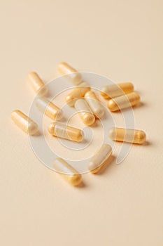 Coenzyme Q10 capsules. Dietary supplements. Bright paper background. Close up.