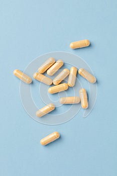 Coenzyme Q10 capsules. Dietary supplements. Bright paper background. Top view.