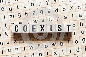 Coexist word concept on cubes photo