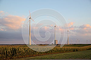 Hand in hand wind mill farm with agricultural fields