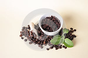 Cofee beans, sugar scrub in ceramic bowl, mint leaves, wooden scoop. Natural home made cosmetics