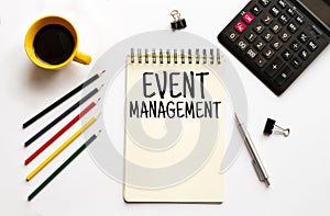 Cofee cup, calculator,notepad,pen and pencils on the white background. Business concept. Text Event Management