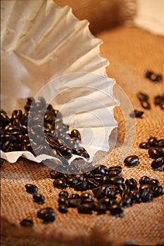 Coffe Beans and filter on burlap.