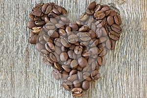 Coffe beans heart on wood background