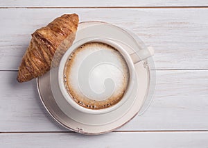 Coffe and croissant wood background morning breakfast top view cappuchino photo