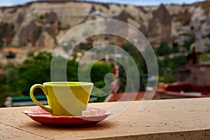 Coffe cup on the balcony overlooking Uchisar Mountain in Cappadocia