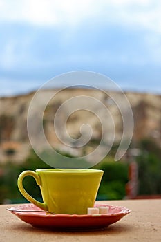 Coffe cup on the balcony overlooking Uchisar Mountain in Cappadocia