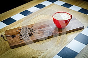 Coffe Cup with Beans on wooden plate