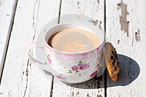 Coffe cup with biscuit and peeling white background