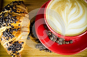 Coffe Cup and Croissant with Beans on Plate