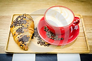 Coffe Cup and Croissant with Beans on Plate