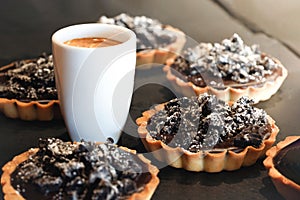 Coffe cup wits delicious chocolate tarts photo