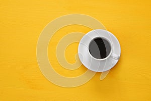 coffe cup on wooden yellow background photo