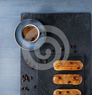 Coffe eclairs with cup of coffee