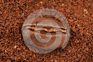 Coffe grain in a boakground of ground coffe photo