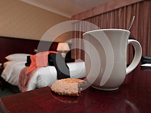 Coffe mug and biscuit in hotel room