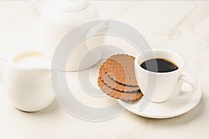 Coffe white cup with cookies and milk/Coffe white cup with cookies and milk on white marble background