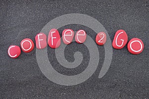 Coffee 2 go, creative logo idea composed with red colored stones over black volcanic sand