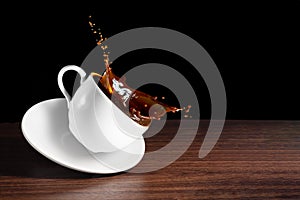 Coffee advertising design. Coffee beans, cup of tilted coffee with a splash effect