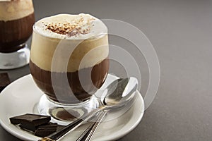 Coffee affogato with vanilla ice cream and espresso. Glass with coffee drink and icecream. Copy space
